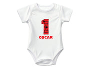 a young boy wearing a white shirt with the number six on it