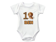 a young boy wearing a lion birthday shirt