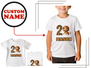 a young boy wearing a lion birthday shirt