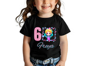 a little girl wearing a black shirt with the number six on it