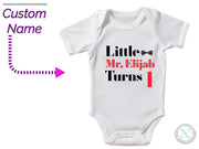 a baby bodysuit with a name and a picture of a train