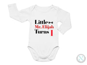 a white bodysuit with the words little, mr elizabeth turns on it