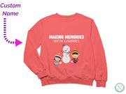 a pink sweatshirt with a picture of a snowman and two children