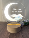 a glass plaque with a crescent and clouds on it