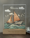 a picture of a sailboat on a wooden stand