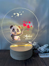 a light up panda bear holding a bunch of hearts