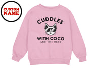 a pink sweatshirt with the words cuddles with coco are the best