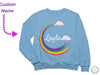 a blue sweatshirt with a rainbow and clouds on it