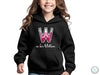 a young girl wearing a black hoodie with the word w is for willow on