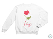 a white sweatshirt with a red flower on it