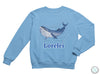 a blue sweatshirt with a whale on it