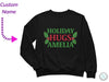 a black sweatshirt with the words holiday hugs amella on it