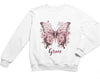 a white sweatshirt with a pink butterfly on it