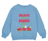 a blue sweatshirt with the words believe in the magic train on it